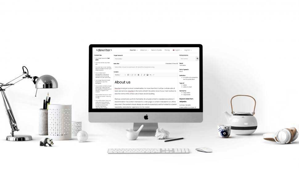 Desktop on desk showing dewriter.com as background